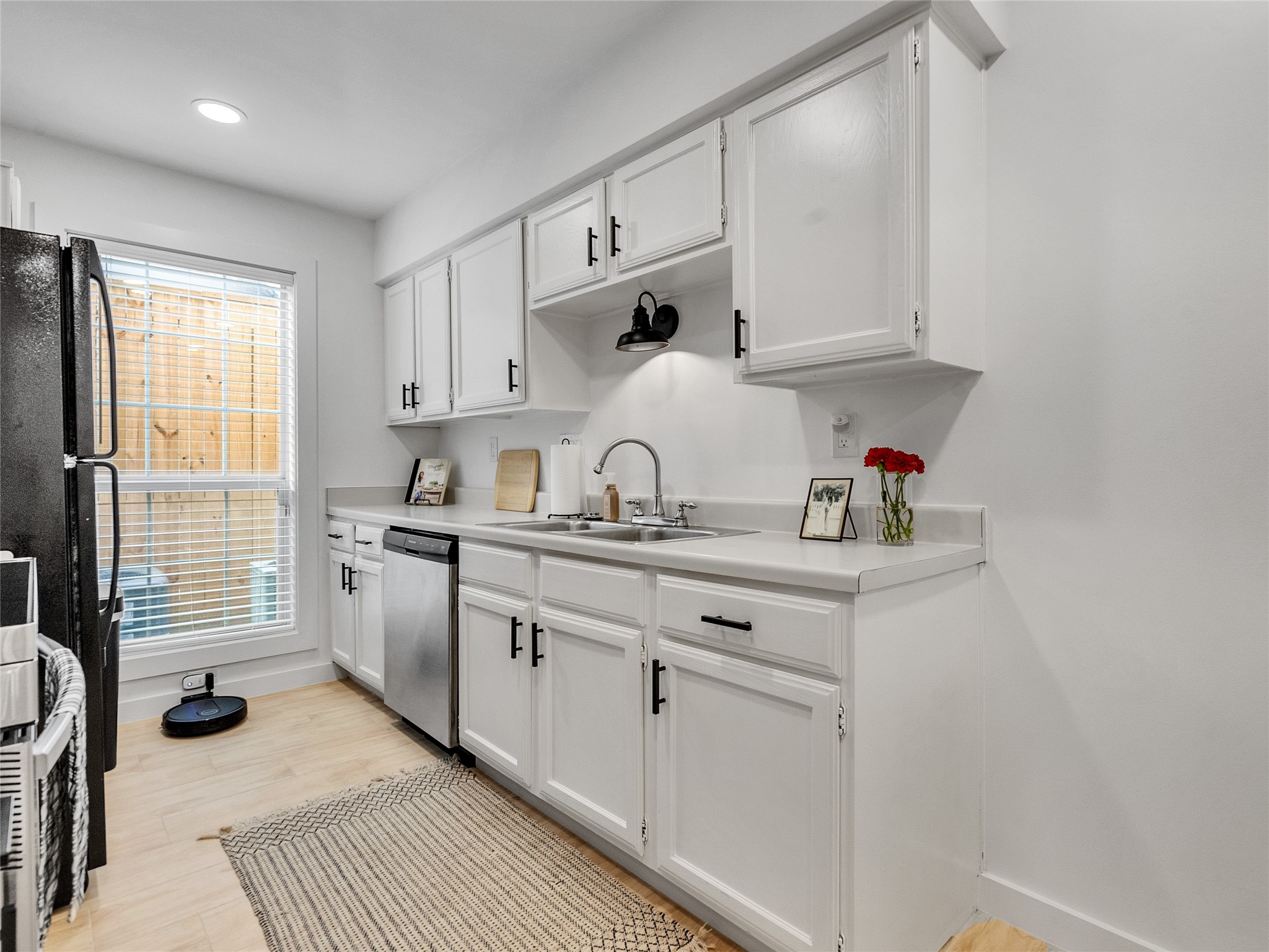 4200 Watson Street, Unit 201 Houston, TX 77009 - Photo 7 of 21 a kitchen with cabinets a sink and appliances