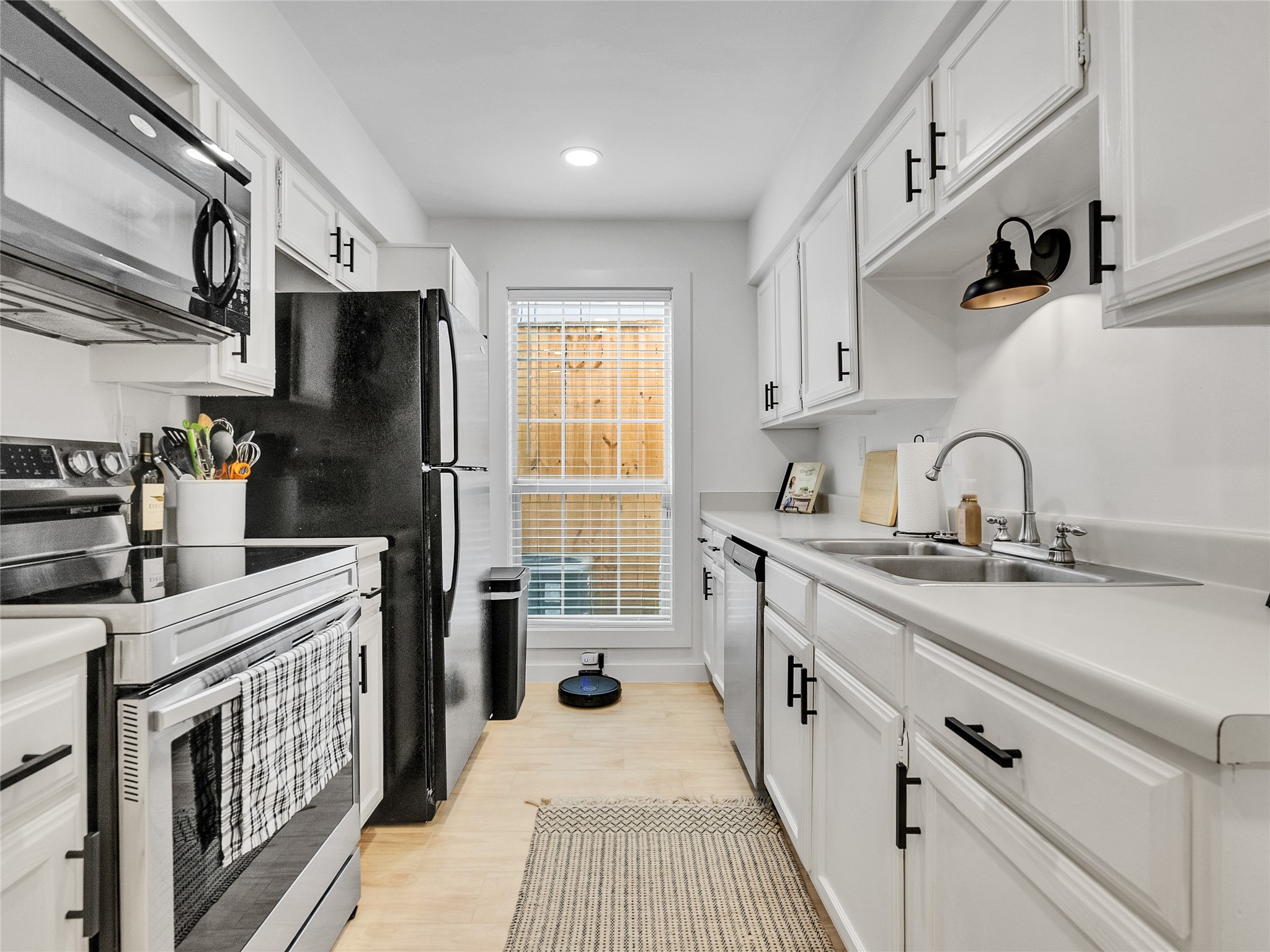 4200 Watson Street, Unit 201 Houston, TX 77009 - Photo 8 of 21 a kitchen with stainless steel appliances granite countertop a sink stove refrigerator and cabinets