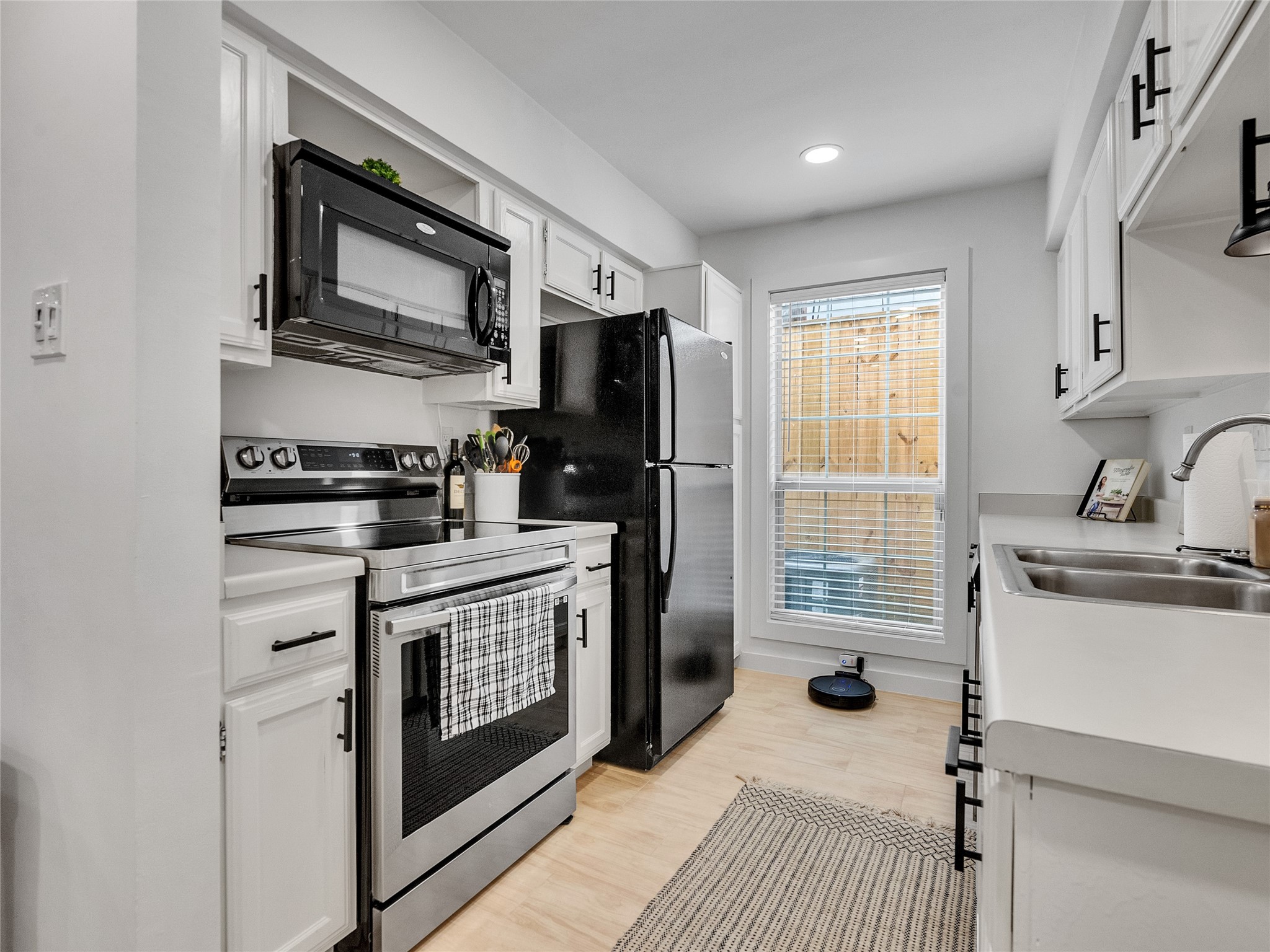 4200 Watson Street, Unit 201 Houston, TX 77009 - Photo 9 of 21 a kitchen with stainless steel appliances a sink stove and refrigerator