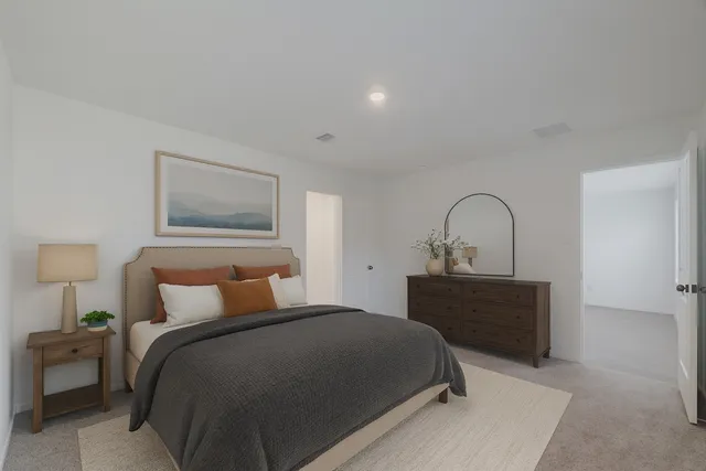 a bedroom with a bed and a dresser