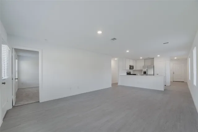 a view of a kitchen with a sink and a refrigerator in it