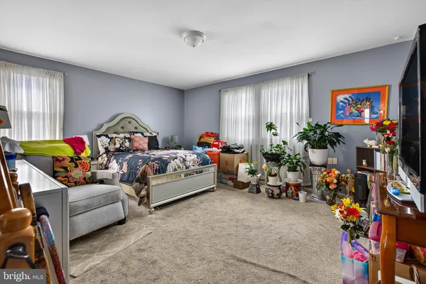 a bed room with furniture and a flat screen tv
