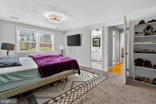 a spacious bedroom with a bed and a window