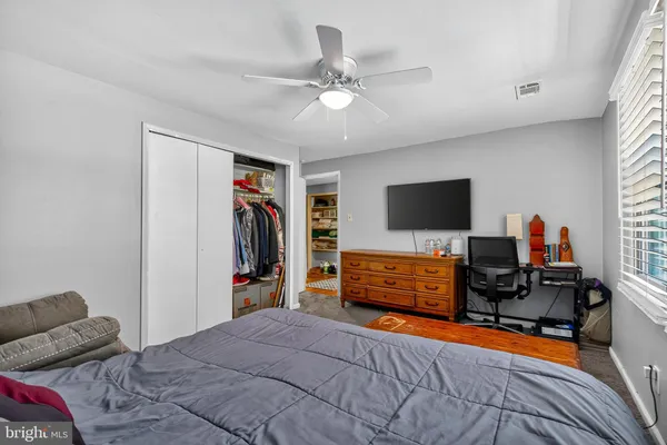 a bedroom with furniture and flat screen tv
