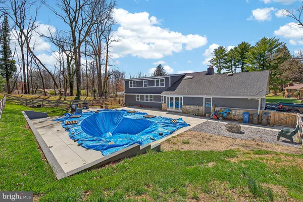 a view of a house with a backyard and a tree