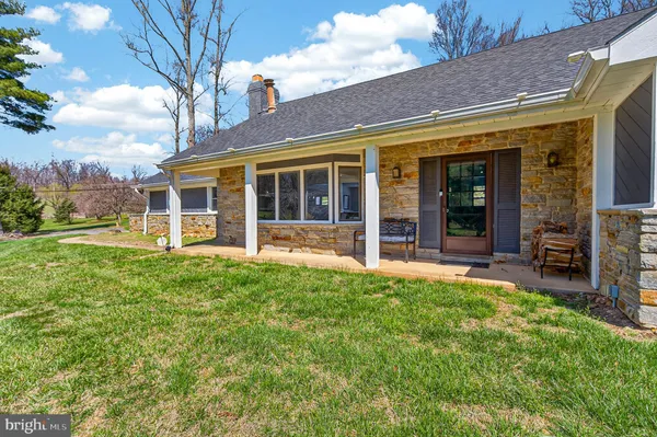 a view of a house with backyard porch and sitting area