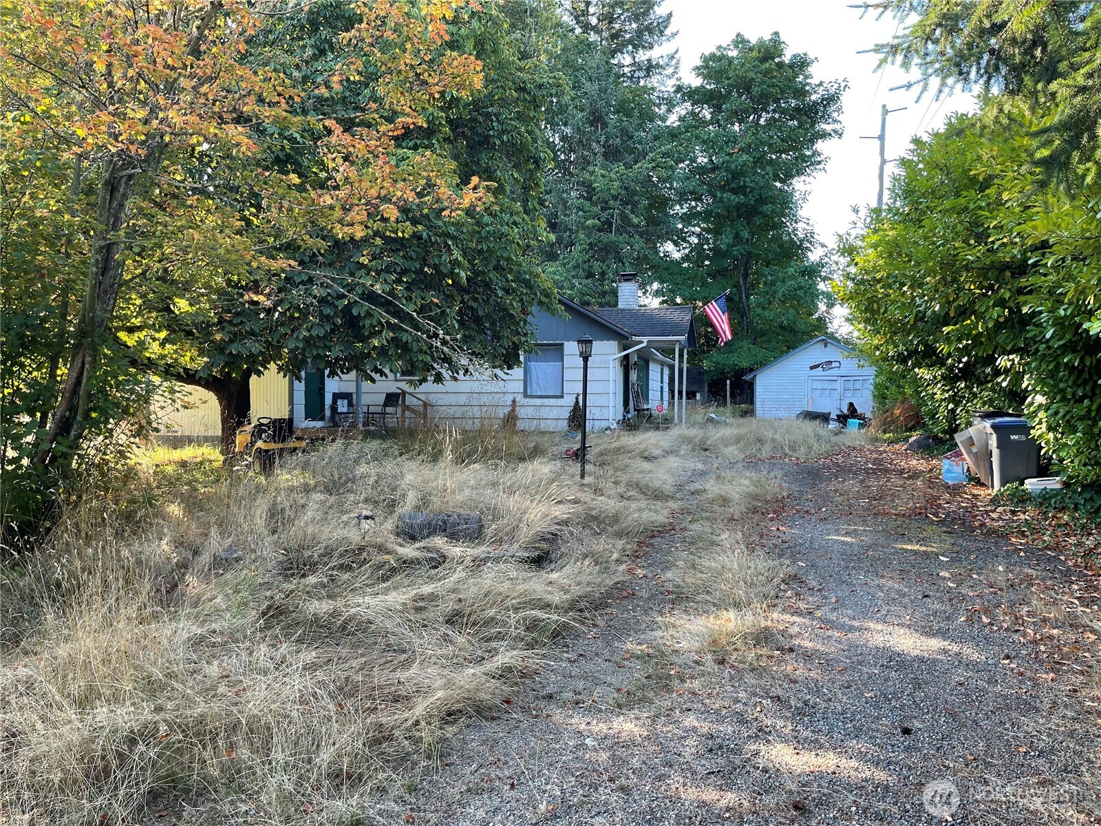 a front view of a house with a tree
