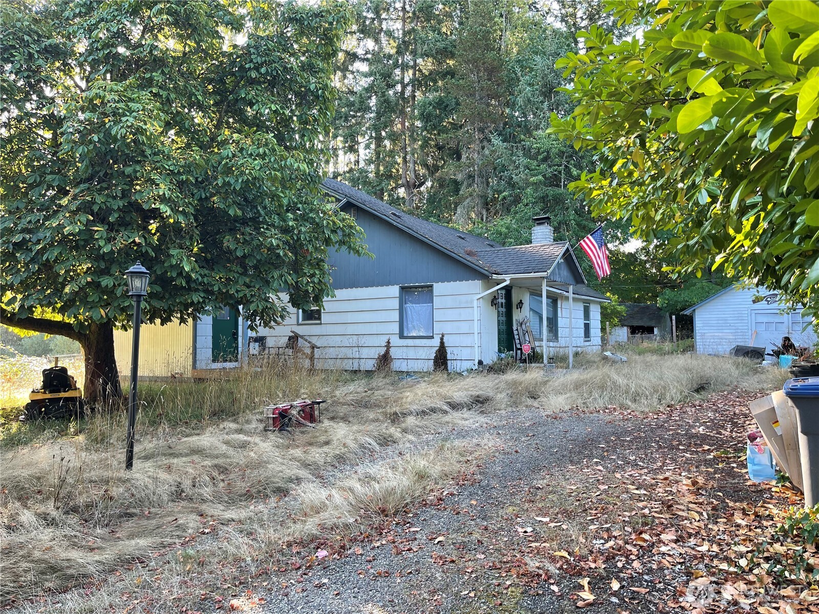16460 Scandia Road Northwest Poulsbo, WA 98370 - Photo 2 of 33 a view of a barn house next to a yard with large trees