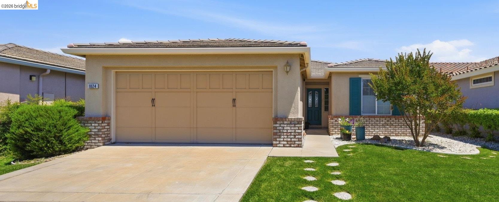 1024 Diamante Rio Vista, CA 94571 - Photo 1 of 27 Front exterior with a two-car garage, concrete driveway, and a front walkway featuring circular stepping stones