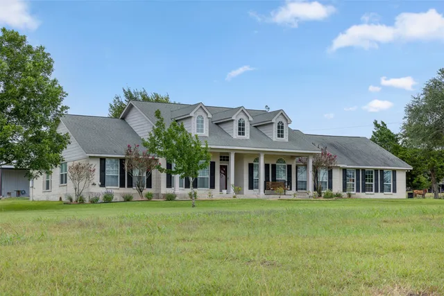 a front view of house with yard outdoor seating and green space