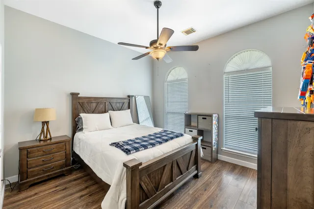 a bedroom with a bed and a chandelier