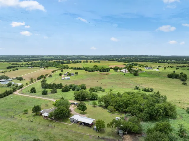 a view of a field with an ocean