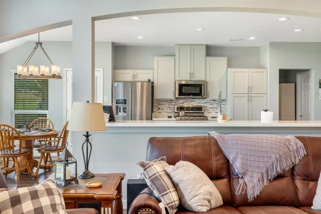 a living room with furniture and a chandelier