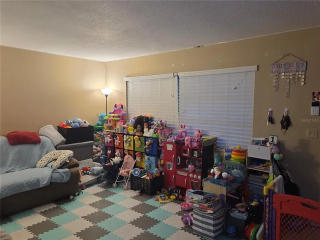 a living room filled with furniture and a potted plant