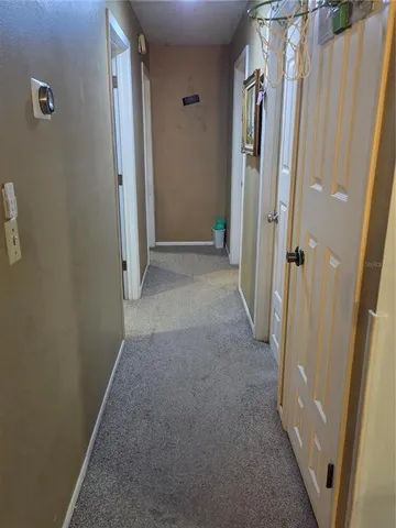 a view of a hallway with a door
