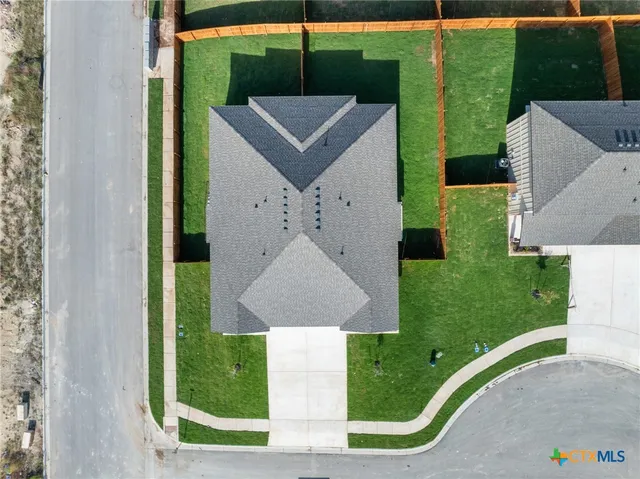 a aerial view of a house with a yard