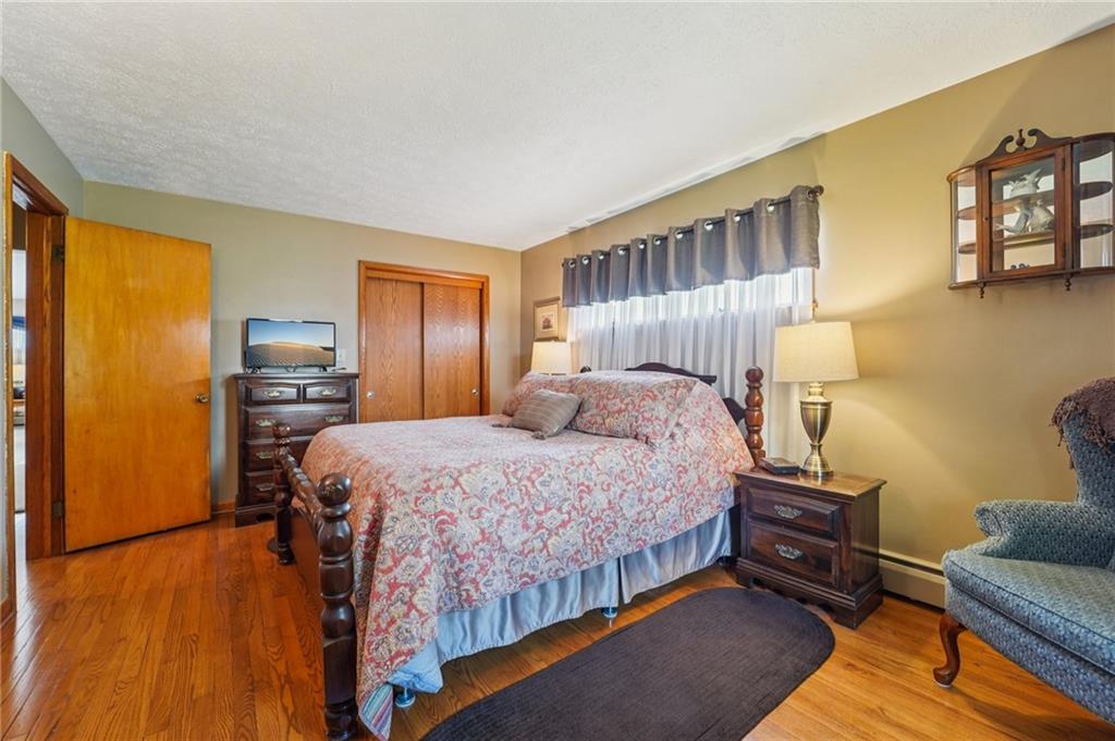 2691 Harlansburg Road New Castle, PA 16101 - Photo 14 of 42 a bedroom with a bed and wooden floor