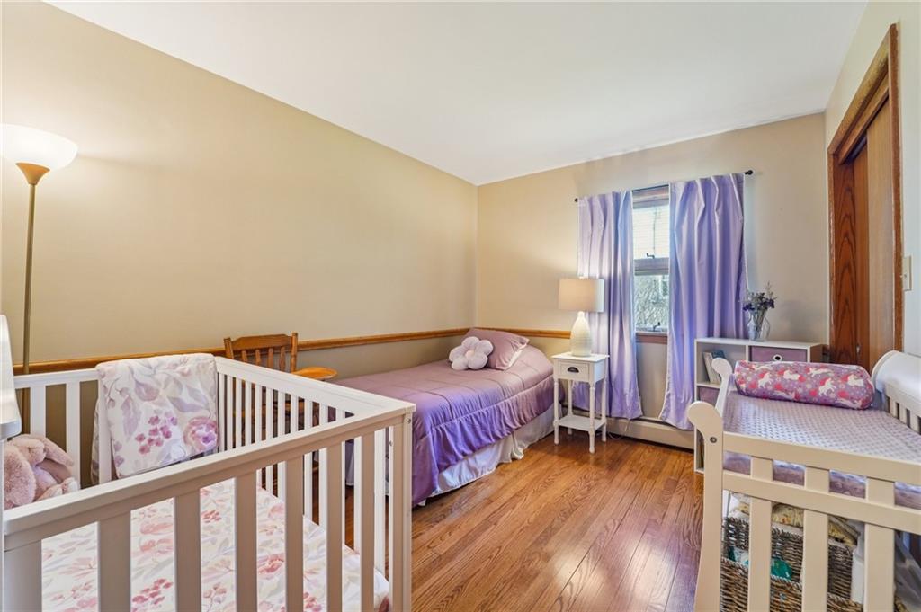 2691 Harlansburg Road New Castle, PA 16101 - Photo 17 of 42 a bedroom with a bed and wooden floor