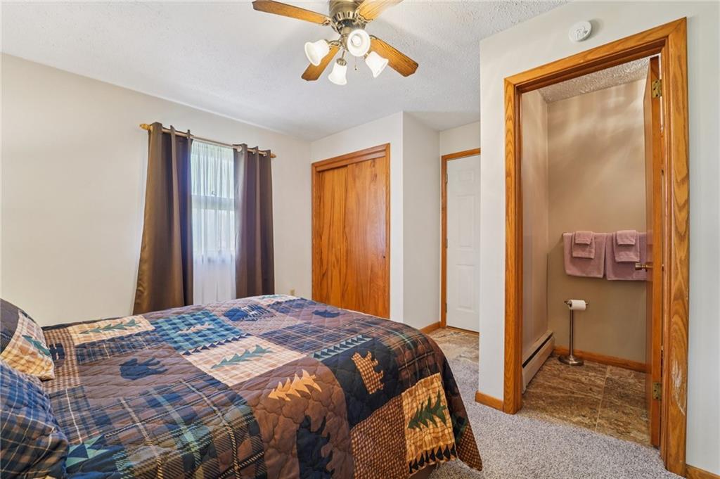 2691 Harlansburg Road New Castle, PA 16101 - Photo 20 of 42 a bedroom with a bed and a chandelier