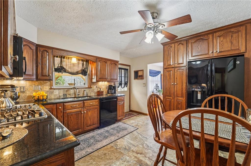 2691 Harlansburg Road New Castle, PA 16101 - Photo 10 of 42 a kitchen with stainless steel appliances granite countertop a sink stove and refrigerator