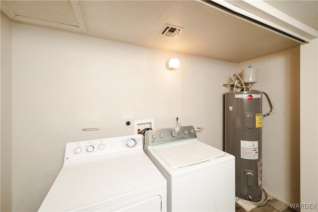 2063 East Sundown Road Kingman, AZ 86409 - Photo 25 of 40 Laundry room with water heater, washing machine and clothes dryer, visible vents, and laundry area