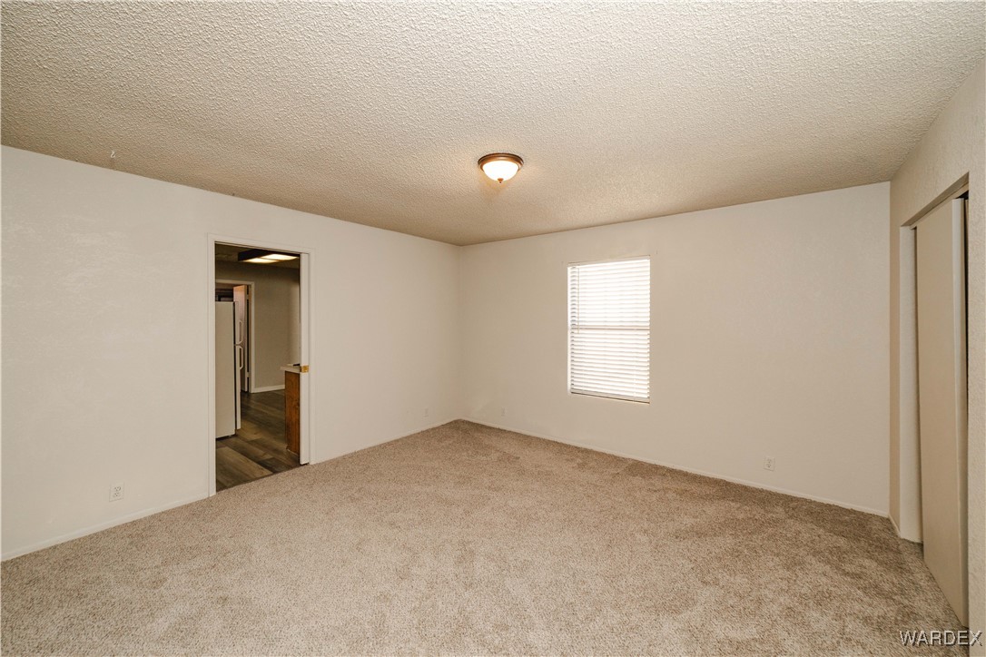 2063 East Sundown Road Kingman, AZ 86409 - Photo 26 of 40 Spare room with carpet and a textured ceiling