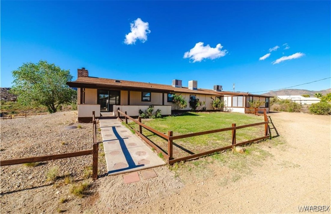 2063 East Sundown Road Kingman, AZ 86409 - Photo 4 of 40 Ranch-style home featuring a chimney, central air condition unit, and a front lawn