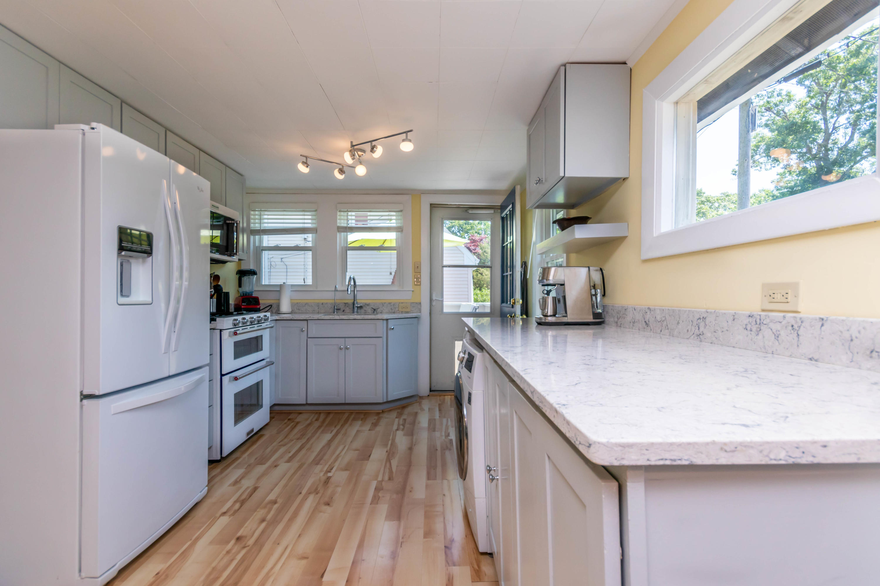 17 Ivy Street Wareham, MA 02571 - Photo 8 of 31 a kitchen with stainless steel appliances granite countertop a refrigerator a sink dishwasher a stove and a dining table with wooden floor