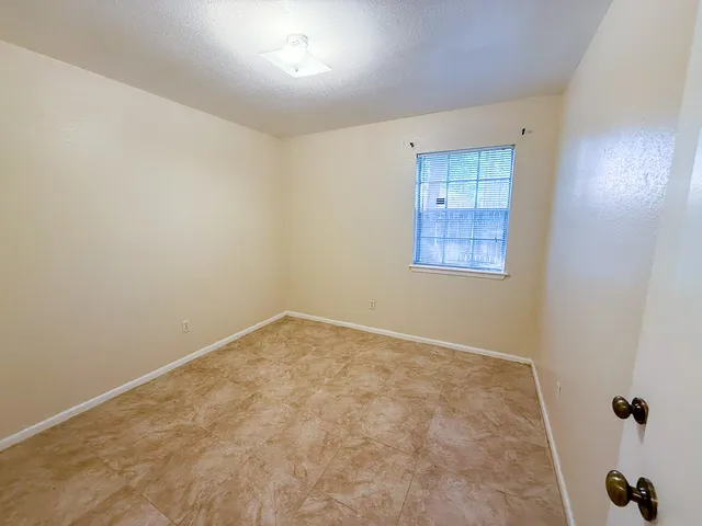 an empty room with a empty space and windows