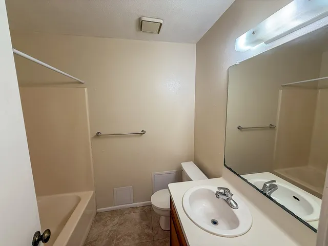 a bathroom with a sink a toilet and tub