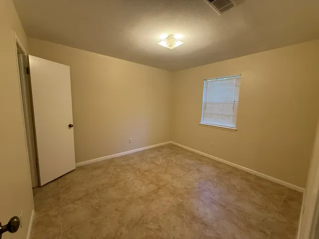 an empty room with a empty space and windows