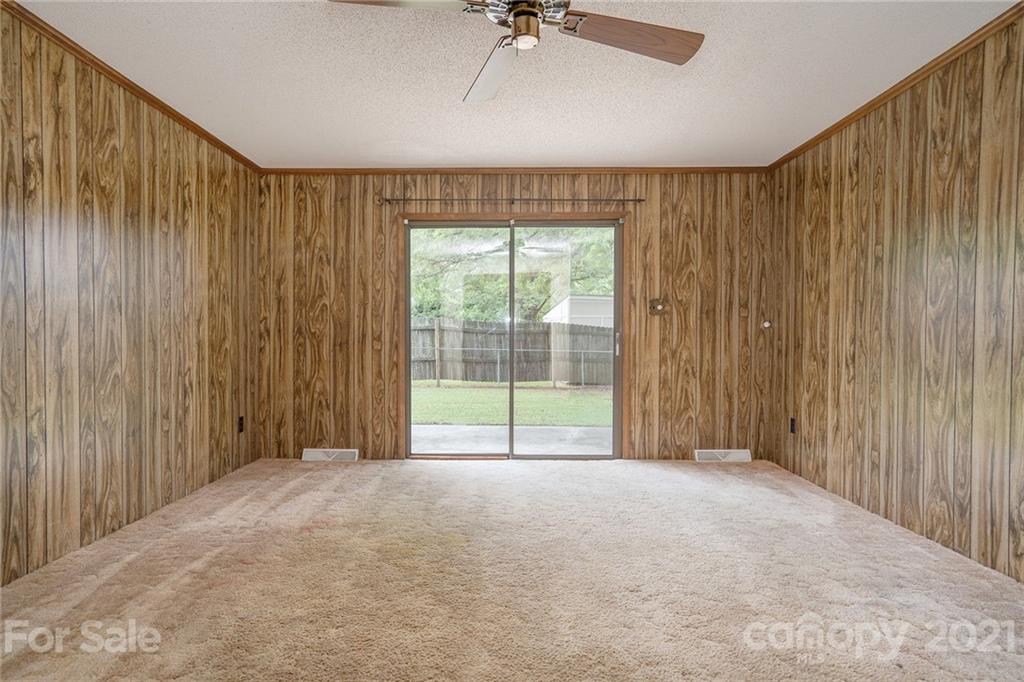 5661 Tuckaseegee Road Kannapolis, NC 28081 - Photo 3 of 18 a view of a big room with windows and chandelier fan