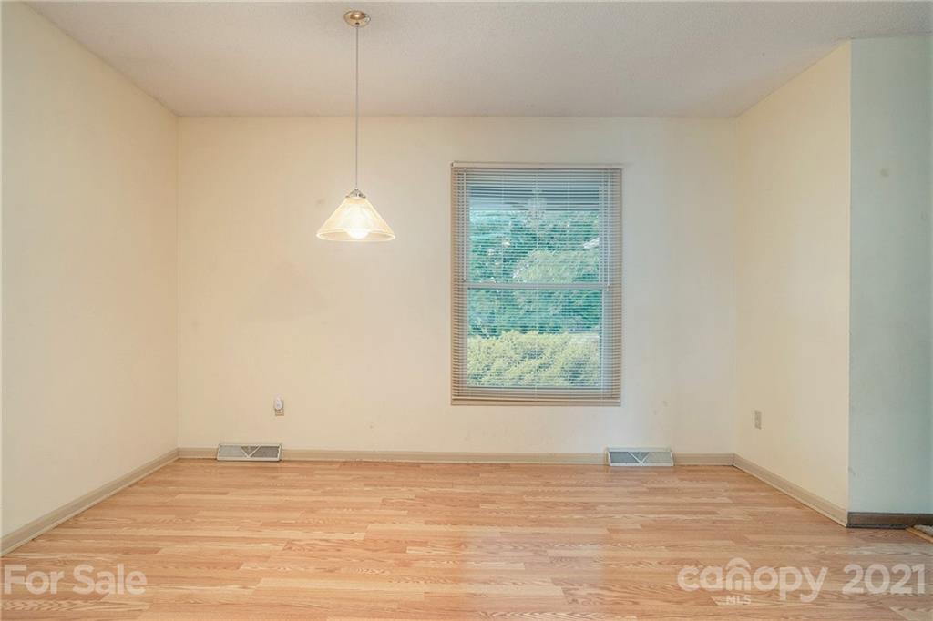 5661 Tuckaseegee Road Kannapolis, NC 28081 - Photo 8 of 18 a view of an empty room with wooden floor and a window