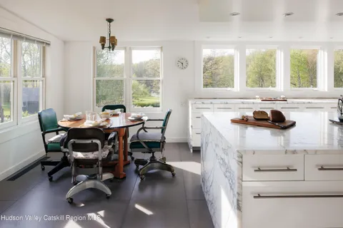 a living room with furniture a window and wooden floor