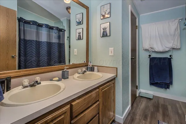 a bathroom with a sink double vanity and a mirror