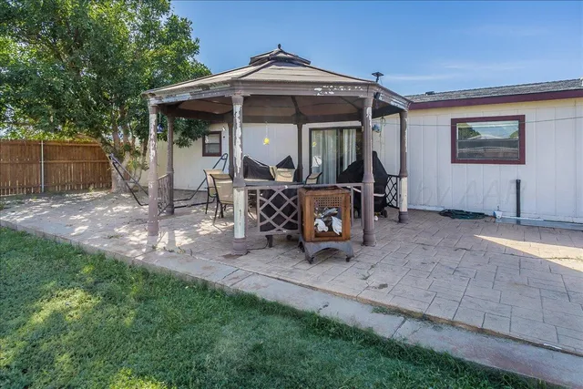 a view of a house with backyard porch and sitting area