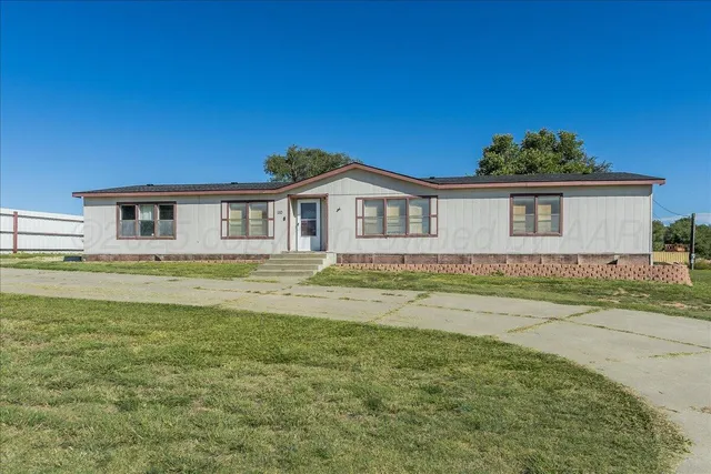 a view of a house with a swimming pool and a yard