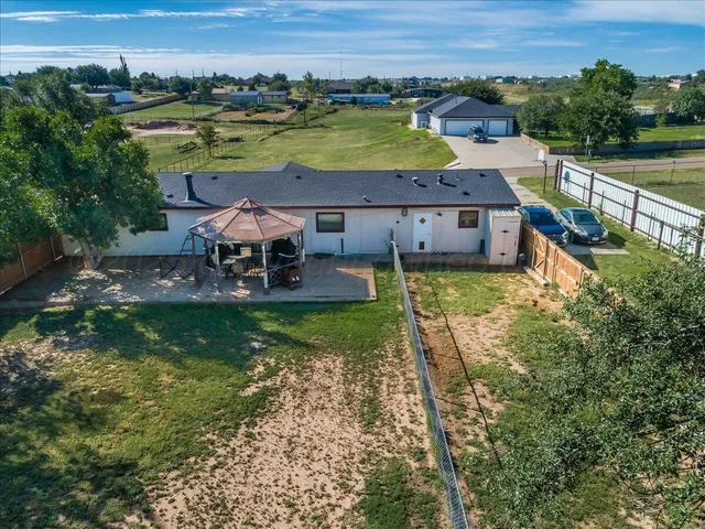 a aerial view of a house with a big yard