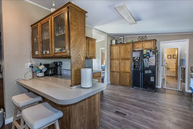 a kitchen with a sink cabinets and wooden floor