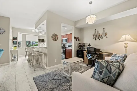 a living room with furniture dining table and a chandelier