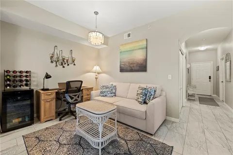 a living room with furniture a dining table and a fireplace