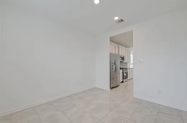 a view of a kitchen with a sink and dishwasher a stove top oven with wooden floor