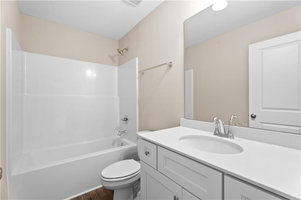 31 Whiterock Road Phenix City, AL 36869 - Photo 32 of 36 Bathroom with bathing tub / shower combination, vanity, and dark wood-style flooring