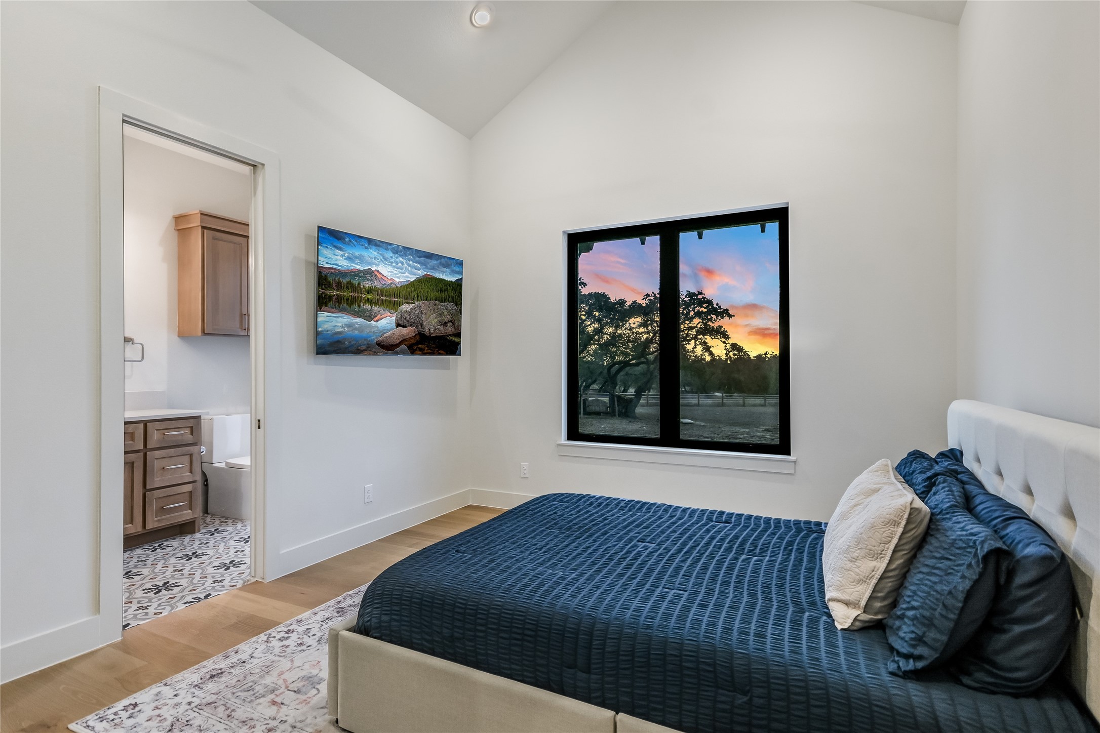 207 Gwendolyns Trail Wimberley, TX 78676 - Photo 29 of 40 a bed sitting in a bedroom next to a window