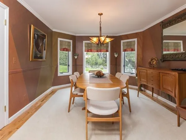 a dining room with furniture a chandelier and window