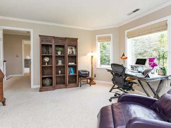 a view of a livingroom with workspace and a window