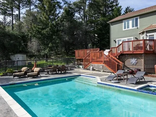 a view of a backyard with sitting area