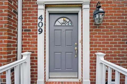a view of a door and brick walls