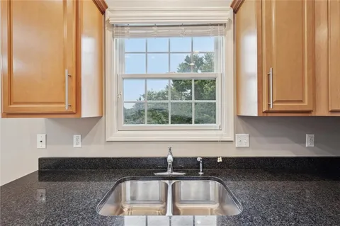 a kitchen with stainless steel appliances a microwave a stove a sink a refrigerator and cabinets