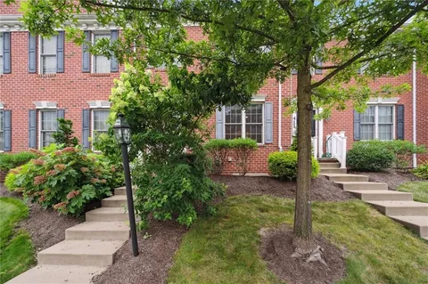 a front view of a house with a garden